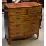 An early 19th century mahogany bowfront chest of two short over three long drawers, raised on