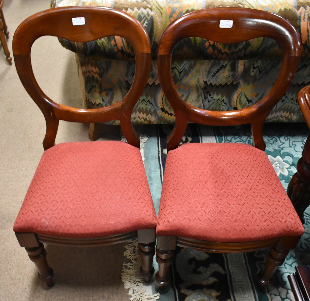 A set of six Victorian mahogany bolt balloon back dining chairs with drop in pad seats on turned