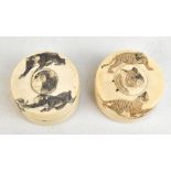 Two Japanese Meiji period ivory lidded trinket boxes, each with carved detail, the larger example