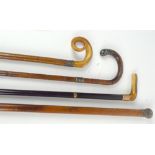 Four walking sticks, one with 9ct rose gold ferrule, two with hallmarked silver ferrules and a