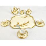 LIMOGES; a part tea service with gilt foliate decoration comprising tea pot, sugar bowl with lid,
