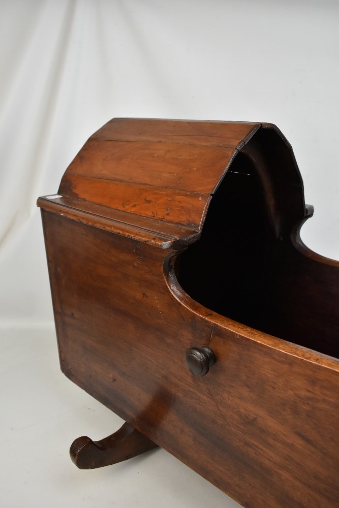 An early 20th century and later stained mahogany and pine child's rocking crib with arched partial - Image 2 of 3