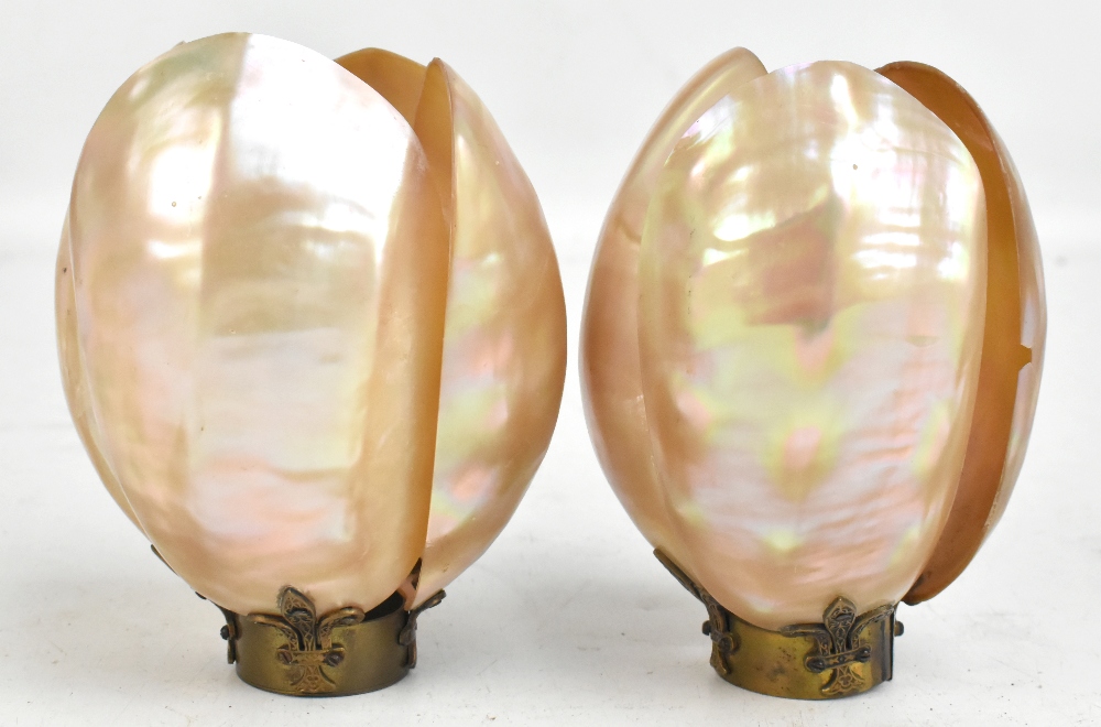 A pair of late 19th century mother of pearl shades on brass stands, each fashioned from four open