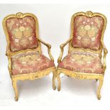 A good pair of 18th century Italian open armchairs with gilt wood frames, padded backs and seats