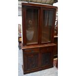 An early 20th century mahogany bookcase, the upper section with twin glazed doors above single