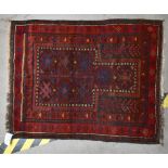 A Western Afghanistan prayer rug with red ground, Belouch Tribes, 108 x 87cm.Additional
