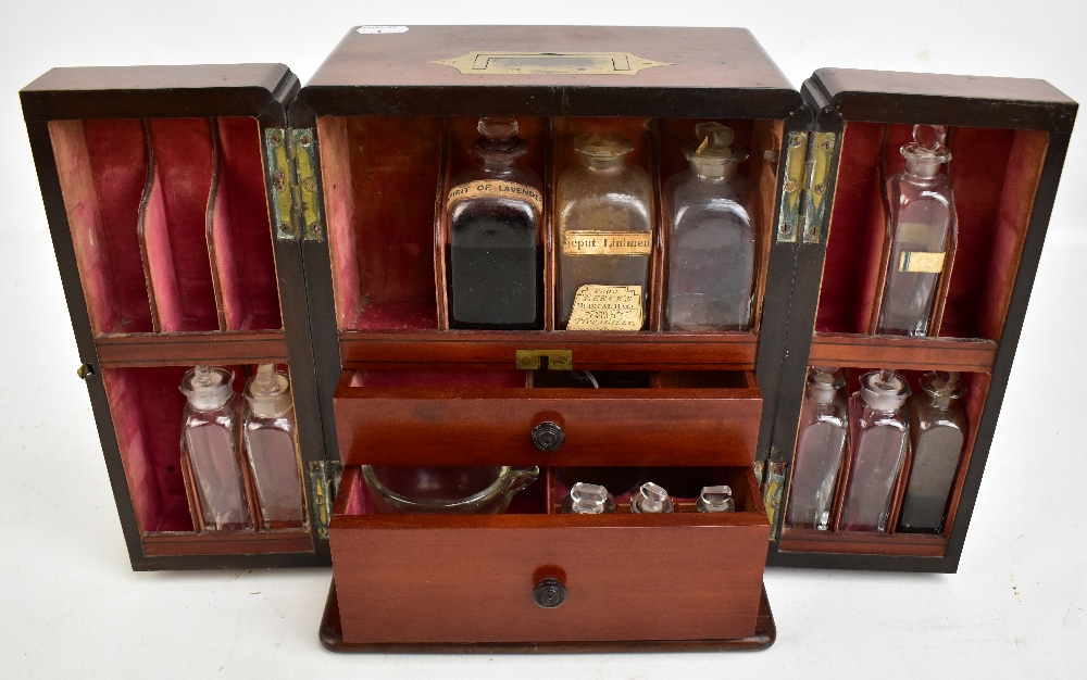 An early 19th century mahogany cased apothecary cabinet, the two hinged doors enclosing a part