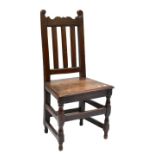 A 19th century carved oak hall chair on bun feet. Additional InformationHeavy wear throughout,