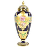 A late 19th/early 20th century Continental porcelain pedestal vase and cover, painted with iris