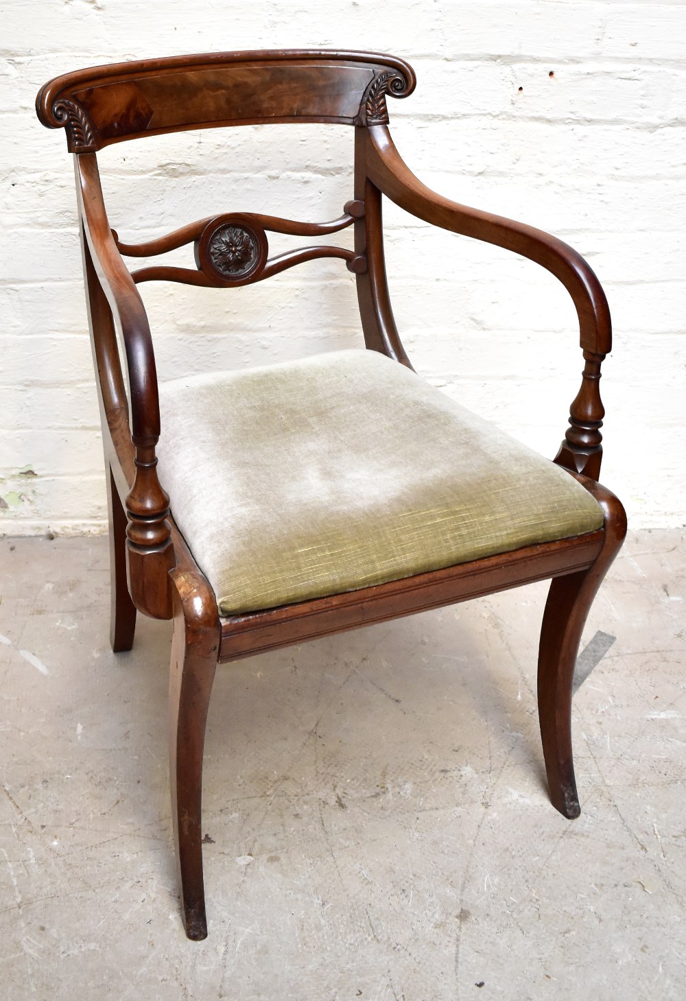 A Regency mahogany bar back armchair with carved detail and drop in seat. Additional