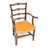 A George III mahogany ribbon ladder back elbow chair on block supports.Additional