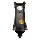 A late 19th century Vienna wall clock with ebonised case, the circular dial set with Roman numerals,