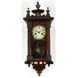 An early 20th century walnut veneered Vienna type wall clock, the circular dial set with Roman