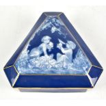 LIMOGES; a pate sur pate triangular box, the lid decorated with two putti and indistinctly signed ‘