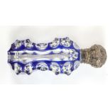 A Victorian faceted glass perfume bottle of waisted form with white metal collar, hinged cover and