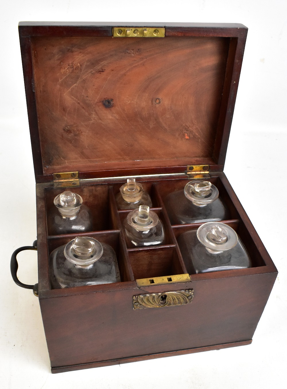 A Georgian mahogany apothecary cabinet, the hinged cover enclosing seven assorted bottles, height of