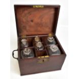 A Georgian mahogany apothecary cabinet, the hinged cover enclosing seven assorted bottles, height of