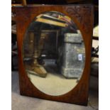 An early 20th century carved walnut rectangular wall mirror with oval bevelled plate, height 67cm,