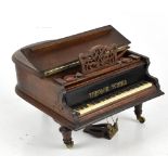 An early 20th century novelty musical jewellery box in the form of a grand piano with hinged lid