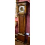 A small early 20th century oak longcase clock with silvered chapter ring inscribed 'E. Buckingham,