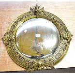 A late 19th century gilt framed convex wall mirror with pierced and relief detail, diameter 62.5cm.