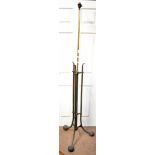 An Arts & Crafts brass plated adjustable standard lamp, raised on three outswept supports, height