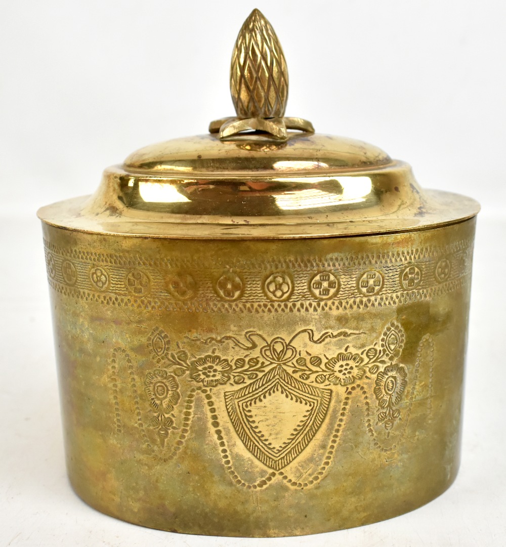 A decorative brass biscuit box with pineapple finial and engraved detail, length 17cm.Additional