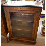 A Victorian inlaid walnut pier cabinet with single glazed door enclosing two fixed shelves, height