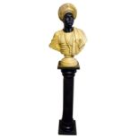 A reproduction Italian carved marble and black slate bust of a blackamoor figure, raised on column
