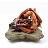 LISA CULLEY; a tree root skull on stone base, signed with artist's plaque, height 24cm.