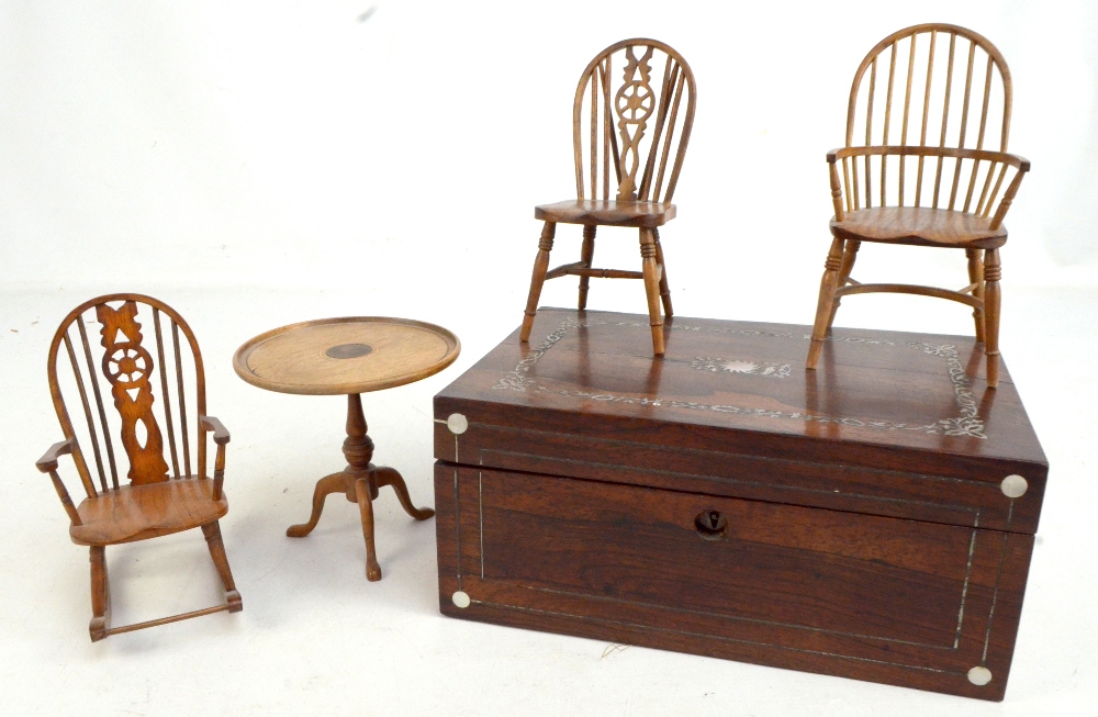 A Victorian rosewood sewing box with mother of pearl floral detail and hinged cover enclosing a