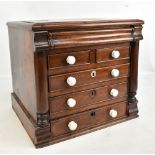 A Victorian mahogany miniature chest with secret drawer above two short and three long drawers, with