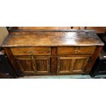 An unusual late George III Irish pine dresser with moulded top above two drawers with simple brass