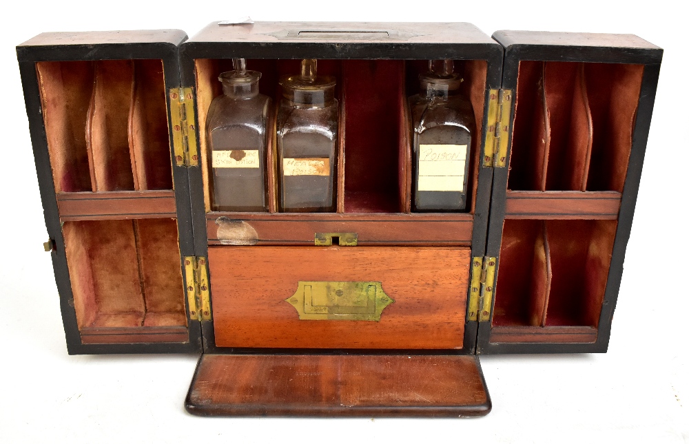 An early 19th century mahogany apothecary cabinet, the two panelled doors enclosing part fitted