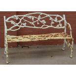 A cast iron white painted garden bench with cast bark and oak leaf style decoration, length 133cm.