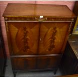 H EPSTEIN; a reproduction mahogany veneered cocktail cabinet, the two panelled doors enclosing a