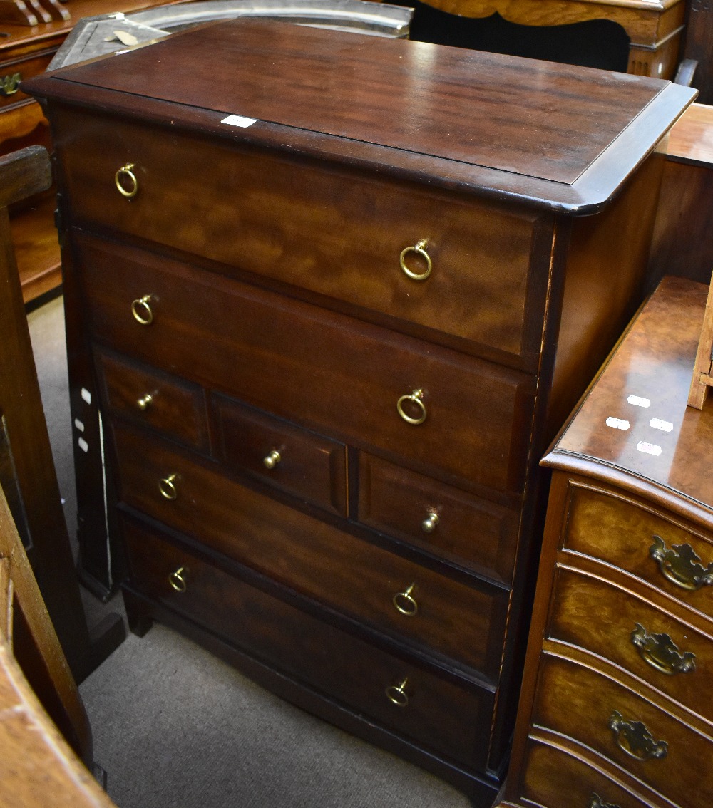 STAG MINSTREL; a narrow chest of seven drawers, raised on block supports, height 112cm, width
