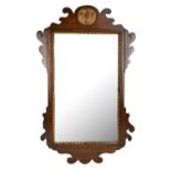 A mahogany fret carved wall mirror with gilt detail and bevelled glass, 73.5 x 46cm.Additional