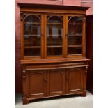 A Victorian mahogany bookcase with moulded cornice above three glazed upper doors and a base of