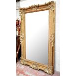 A huge gilt framed rectangular wall mirror with moulded Rococo style detail, height 221cm, width