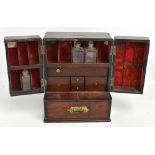An early 19th century mahogany apothecary cabinet, the twin doors enclosing fitted compartments