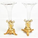 A pair of decorative silvered and gilt metal mounted epergnes with detachable clear glass trumpet