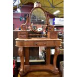 A Victorian carved walnut dressing table with oval mirror and an arrangement of five drawers, height