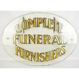 An oval advertising glass sign, 'Complete Funeral Furnishers', 41.5 x 60cm (af).Additional