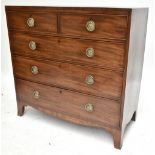 A Georgian mahogany straight front chest of two short over three long drawers, raised on bracket