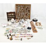 A collection of reproduction modern porcelain teapots and a collection of modern thimbles.