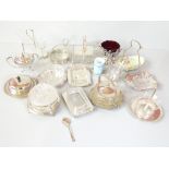 A group of silver plated and mounted butter dishes, sugar bowls and condiment sets including