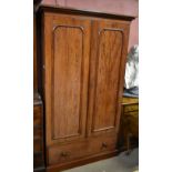 A Victorian mahogany two door wardrobe with moulded cornice above arched panelled doors and single