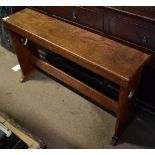 An Arts and Crafts oak bench with carved love heart side panels, length 118cm.