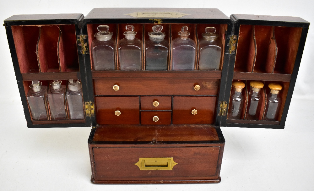 A large 19th century mahogany apothecary cabinet, the two hinged doors enclosing a part fitted